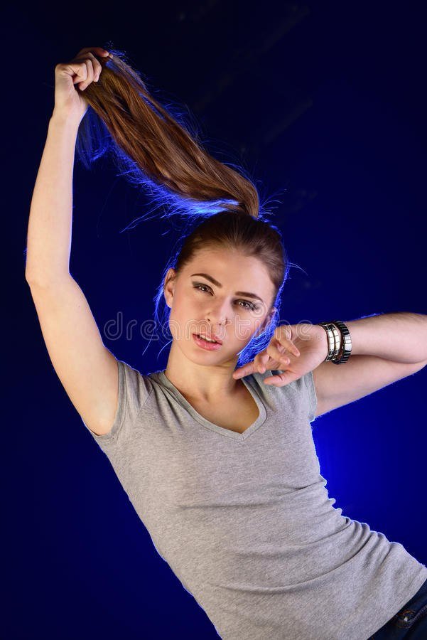 girl yanks her high ponytail up lazily as she uses it as an antenna to think